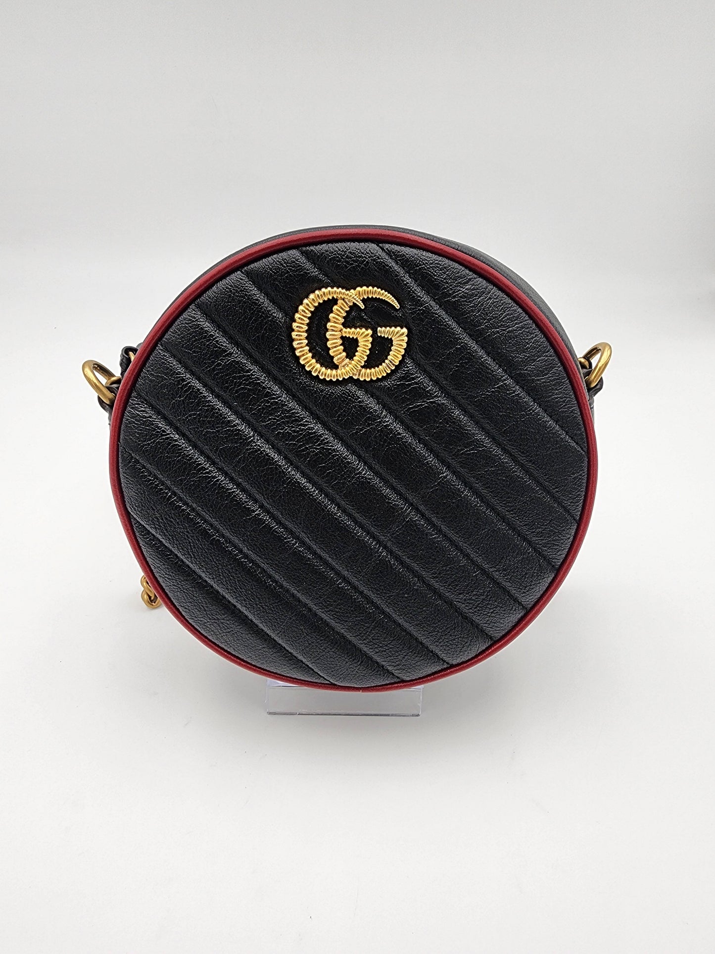 Gucci GG Marmont Mini Round Shoulder Bag In Black Matelasse Calfskin Leather With Red Piping