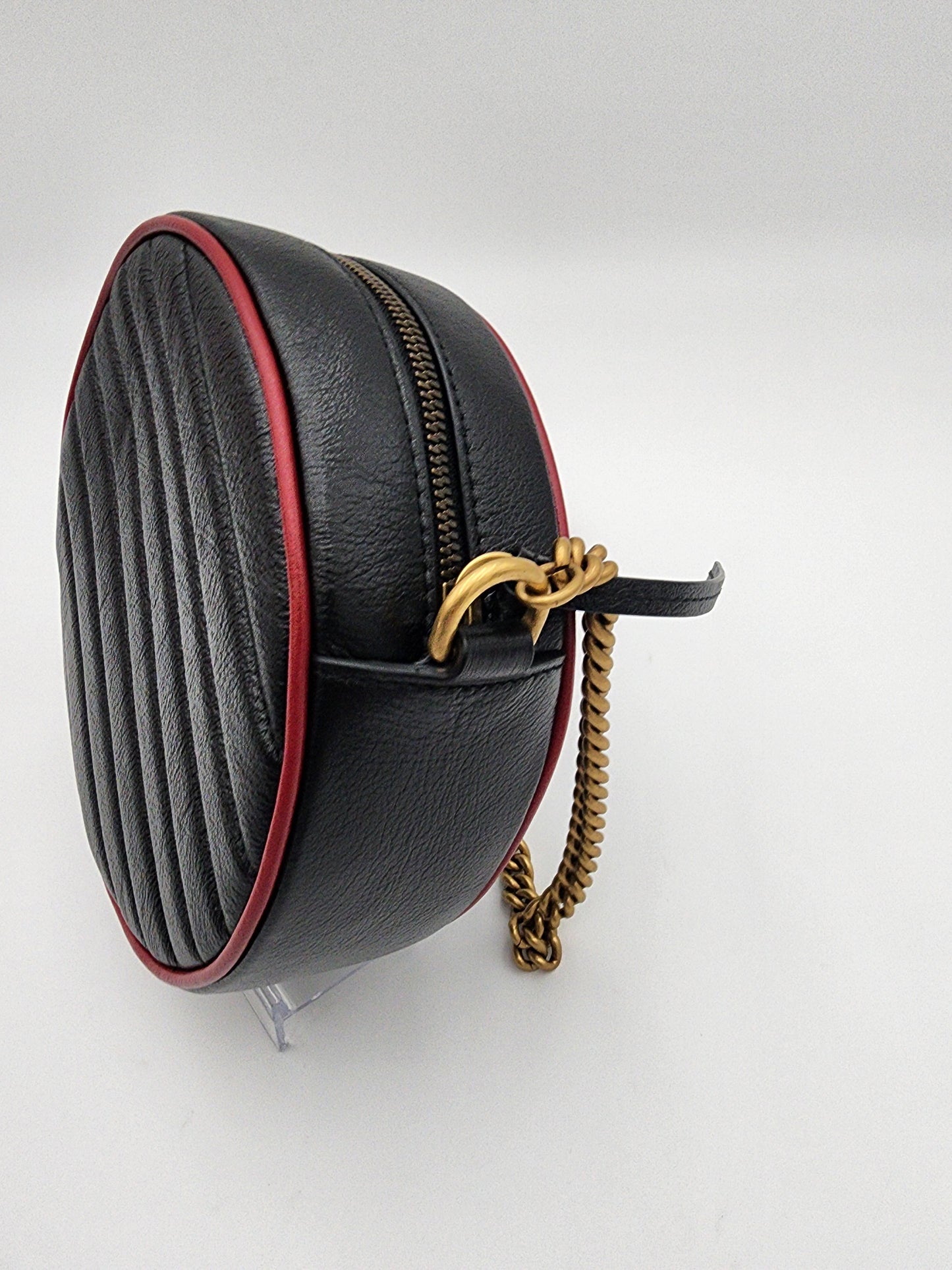 Gucci GG Marmont Mini Round Shoulder Bag In Black Matelasse Calfskin Leather With Red Piping