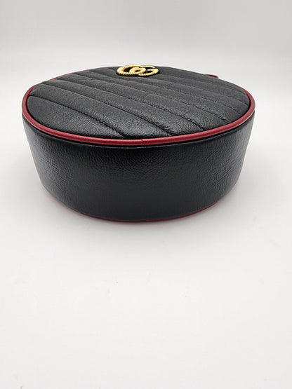 Gucci GG Marmont Mini Round Shoulder Bag In Black Matelasse Calfskin Leather With Red Piping