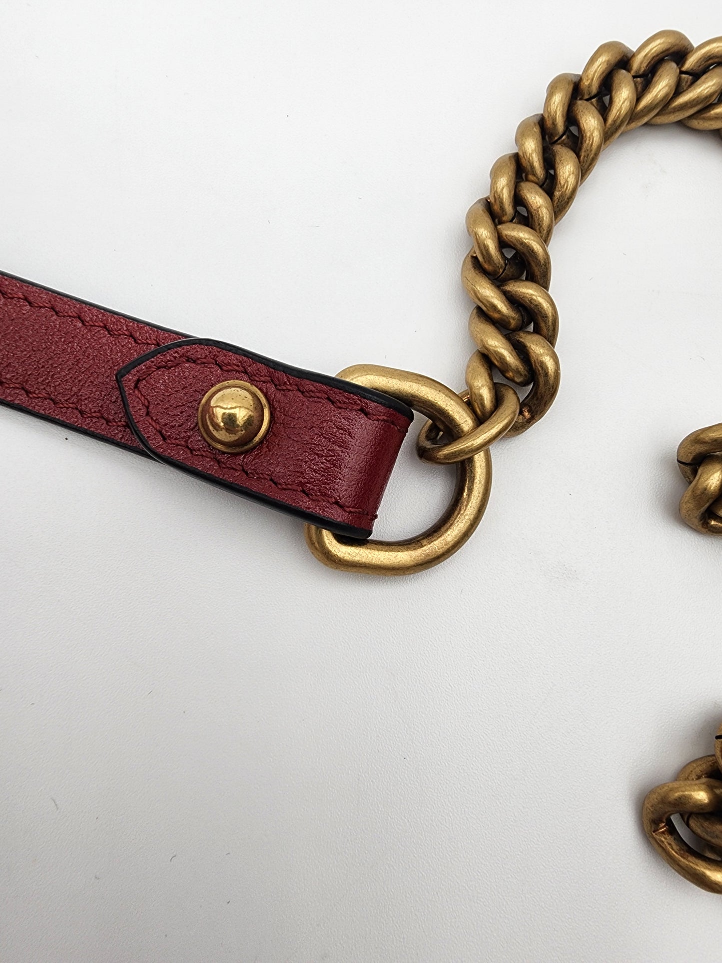 Gucci GG Marmont Mini Round Shoulder Bag In Black Matelasse Calfskin Leather With Red Piping